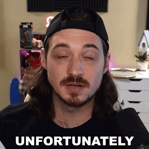 a man with a beard wearing a hat says " unfortunately " in front of a microphone
