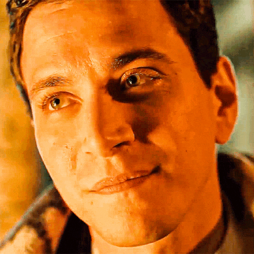 a close up of a man 's face with a shadow on his forehead
