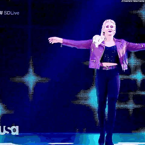 a woman is standing in front of a sign that says charlotte flair on it
