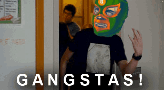 a man wearing a mask and a shirt that says gangstas on it