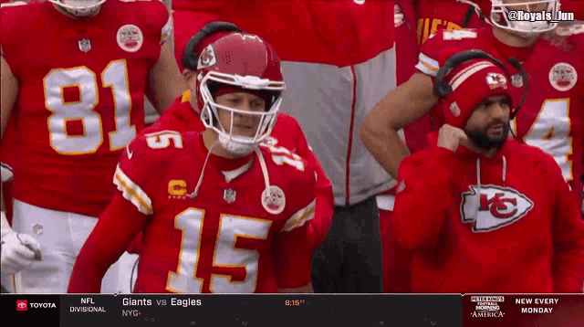 a football player wearing number 15 stands in the stands