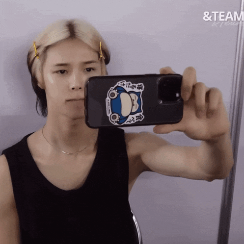 a person is taking a picture of themselves with a phone with a sticker on it