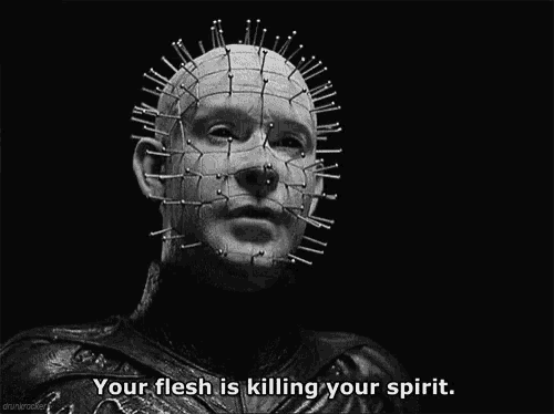 a black and white photo of a man with spikes on his face and the words " your flesh is killing your spirit "
