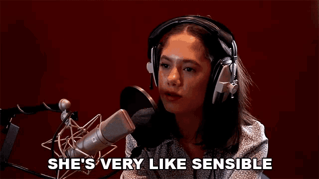 a woman wearing headphones speaking into a microphone with the words she 's very like sensible written below her