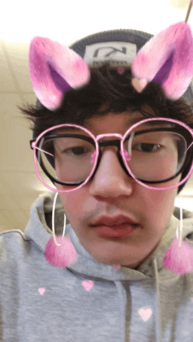 a man wearing bunny ears glasses and a hat that says n on it