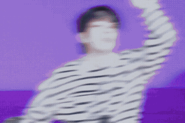a blurry picture of a person wearing a striped shirt