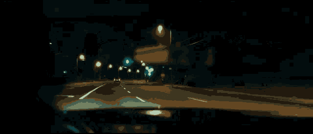 a man with a cigarette in his mouth is driving a car at night