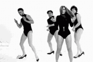 a group of people are dancing together in black leotards .