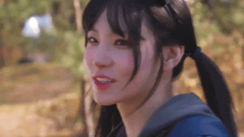 a close up of a girl with pigtails and a backpack