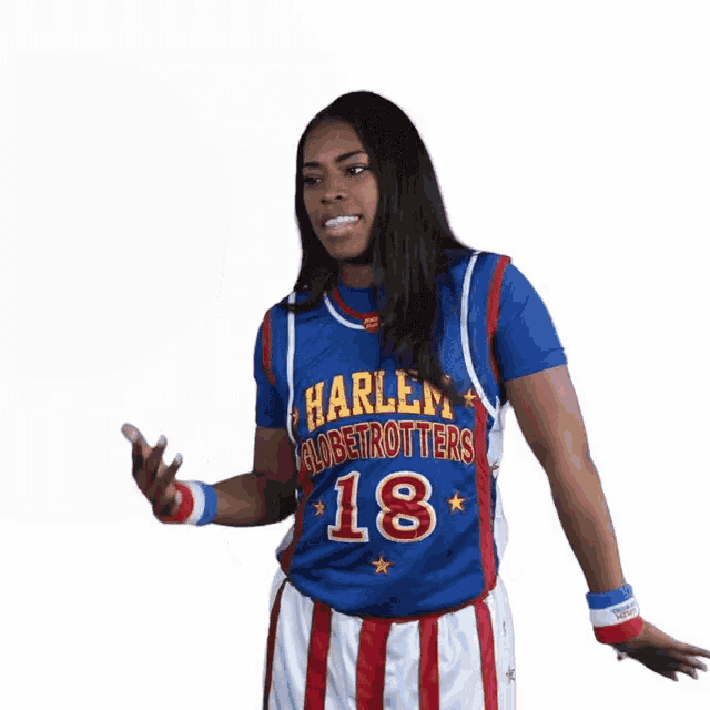 a woman in a harlem globetrotters jersey and shorts is dancing .