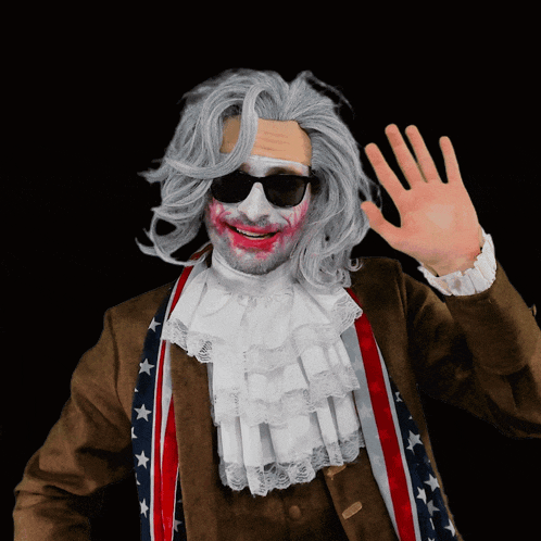 a man wearing a wig and sunglasses is waving his hand in front of a black background