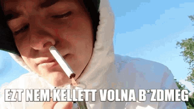 a man smoking a cigarette with the words ezt nem kellett volna b * zdmeg written above him