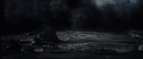 a person is standing on a rock in the middle of a destroyed area