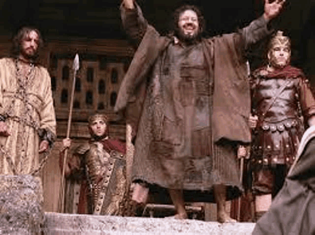 a group of roman soldiers are standing next to each other on a stage .