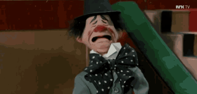 a clown with a top hat and bow tie is being shown on tv
