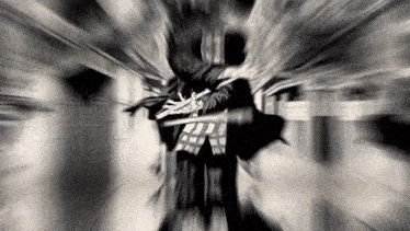 a blurry black and white photo of a person with a sword
