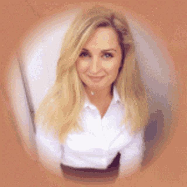 the woman is wearing a white shirt and smiling for the camera