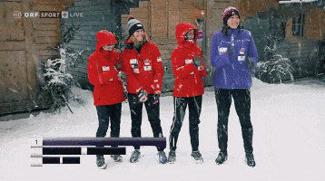 a group of people standing in the snow with hd orf sport live on the bottom right