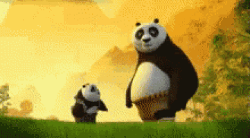 two panda bears are standing next to each other on a hill .