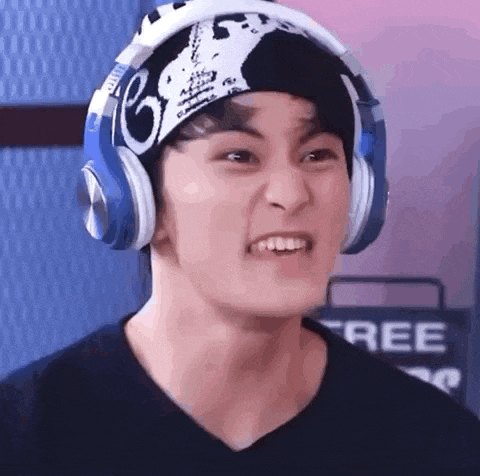 a close up of a person wearing headphones and a beanie .