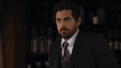 a man with a beard in a suit and tie