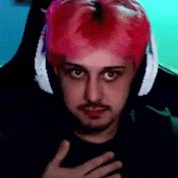 a man with pink hair is wearing headphones and a black shirt .