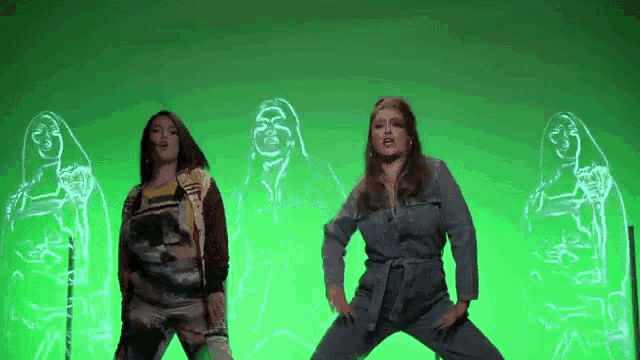 a group of women are dancing on a green screen .