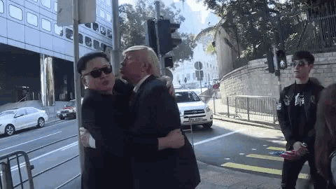 a man in a suit and tie is hugging another man