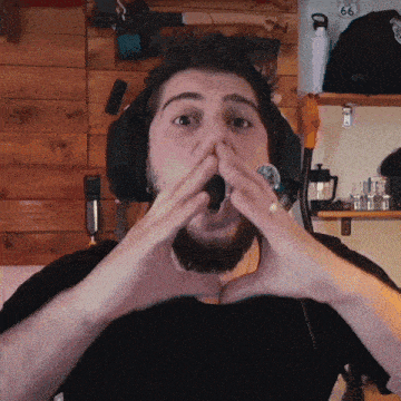 a man wearing headphones holds his hands to his face in front of a sign that says 66