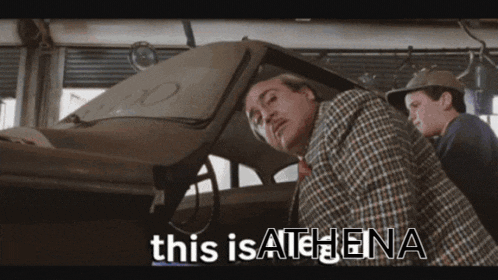 a man in a plaid shirt is standing next to a man in a hat and the words this is athena are on the screen