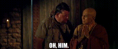two men are standing next to each other and one of them is talking to the other .