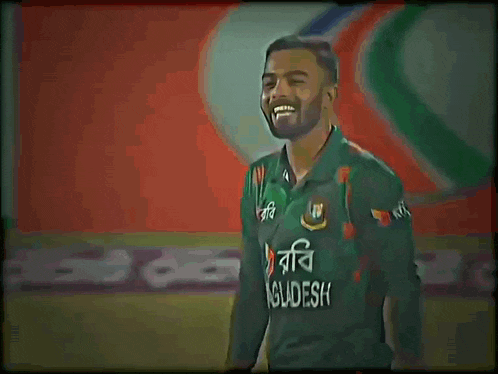 a man in a green bangladesh jersey smiles