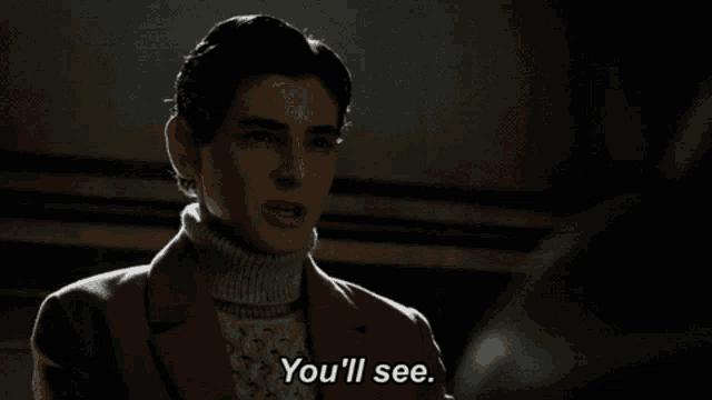 a man in a turtleneck sweater says " you 'll see "