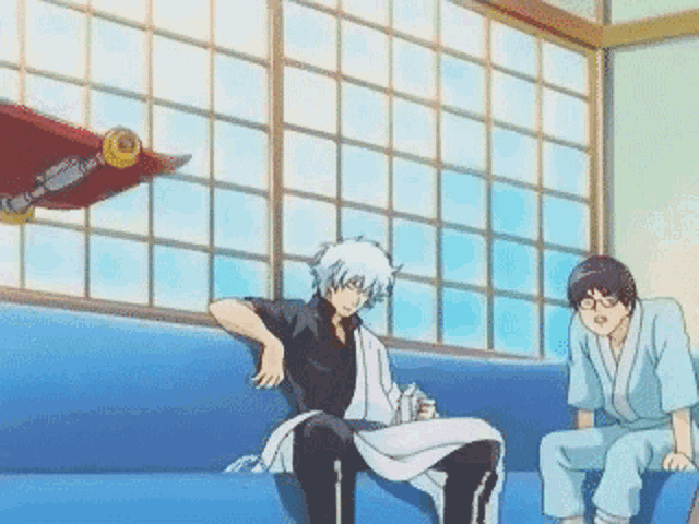 two anime characters sitting on a blue couch