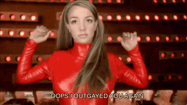 a woman in a red leather outfit is saying oops i outgayed you again