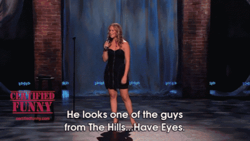 a woman stands on stage with a microphone and says he looks one of the guys from the hills ... have eyes