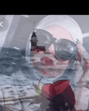 a woman wearing sunglasses and a hijab with a rose in front of her