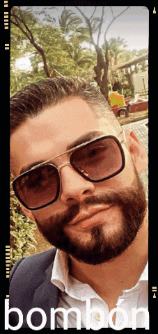 a man with a beard wearing sunglasses with the word bombon on the bottom right