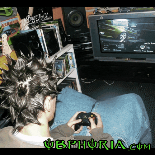 a man with a mohawk is playing a video game with the website obphoria.com visible in the corner