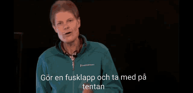 a man in a green jacket is giving a presentation