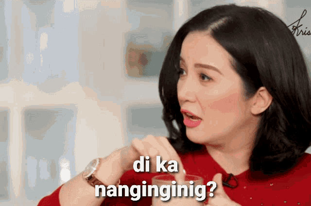 a woman in a red shirt is holding a glass with the words di ka nanginginig written on it