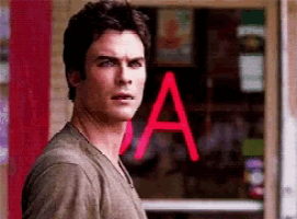 a man is standing in front of a red sign that says a.