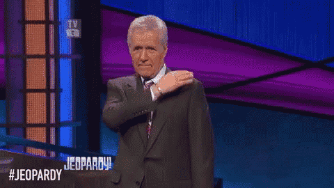a man in a suit and tie is on a jeopardy stage