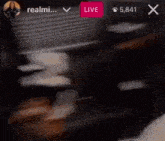 a blurred image of a person 's face with a live button in the corner