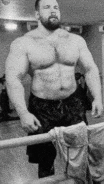 a man without a shirt is standing in front of a mirror