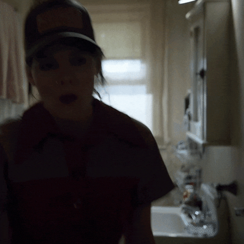 a woman wearing a hat with a sticker on it that says ' mcdonald 's '