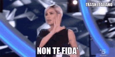 a woman is standing on a stage with the words non te fida written on her face .