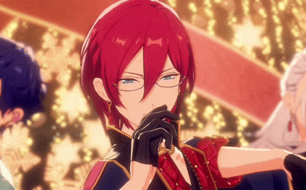 a man with red hair and glasses is standing in front of a crowd .