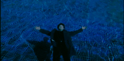 a person is floating in a pool of blue water