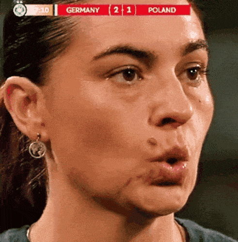 a close up of a woman 's face with a scoreboard that says germany 2 1